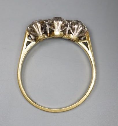 An 18ct and plat set three stone diamond ring, size M/N, gross 2.8 grams,